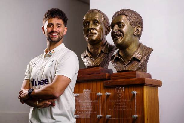 Brett D'Oliveira with busts of grandfather Basil and father Damian
